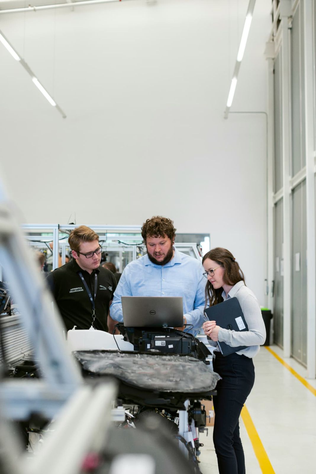 Project engineers reviewing information together on a laptop.